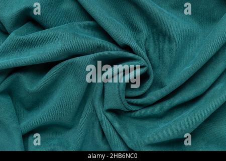 sfondo tessuto verde. motivo tessuto stropicciato a spirale Foto Stock