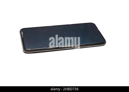 Smartphone con schermo rotto. Isolato su sfondo bianco. Vista dall'alto. Foto Stock