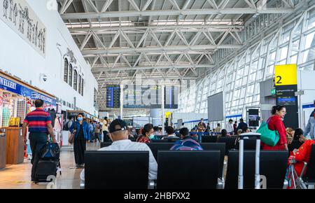 Passeggeri in attesa nell'area salotto presso il cancello d'imbarco all'Aeroporto Nazionale di Chennai. Foto Stock