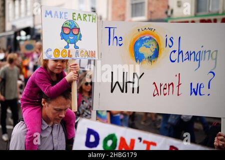 Foto del file datata 24/09/21 di genitori e bambini che partecipano ad uno sciopero climatico giovanile globale. Gli alunni, i genitori e gli insegnanti eco-coscienti chiedono maggiore azione sulla crisi climatica durante la stagione delle feste. Foto Stock