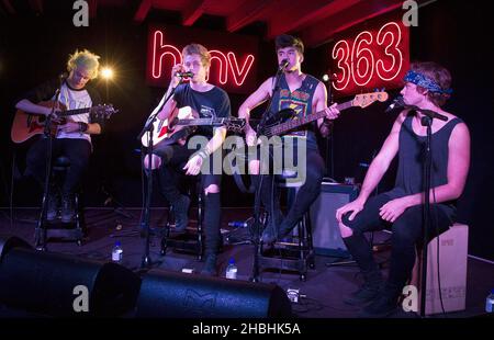 (Sinistra - destra) Michael Clifford, Luke Hemmings, Calum Hood e Ashton Irwin di 5 secondi d'estate suonano sul palco acustico all'HMV Oxford Circus di Londra. Foto Stock