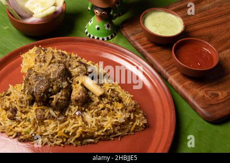 Shot del piccante montone biryani servito in un piatto marrone Foto Stock