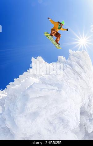 Snowboarder jumping contro il cielo blu in alta montagna Foto Stock