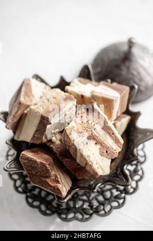 piatto con halva in semi di girasole su vassoio di bronzo, fuoco selettivo. Vita morta con halva in stile arabo. Foto Stock