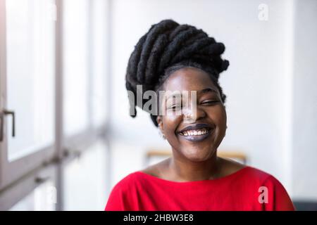 Ritratto di una giovane donna sorridente in casa Foto Stock