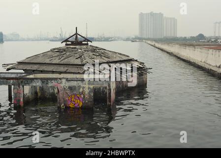 Un edificio della moschea che è stato abbandonato per decenni a causa dell'aumento del livello del mare, l'abrasione costiera e la sussistenza della terra sulla zona costiera di Jakarta, Indonesia. Foto Stock