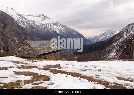 Vista nei pressi di Macugnaga, Piemonte, Italia con chalet e neve Foto Stock