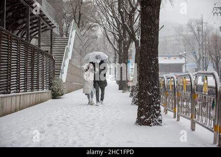 Seul, Corea del Sud. 18th Dic 2021. La gente cammina nella neve in una strada a Seoul, Corea del Sud, 18 dicembre 2021. Credit: Wang Yiliang/Xinhua/Alamy Live News Foto Stock