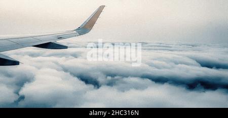 Volare sopra le nuvole soffici su un aereo per le vacanze estive, AEREO Foto Stock