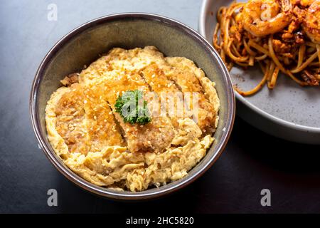 Una ciotola di cotoletta di maiale con uova e riso Foto Stock