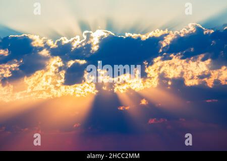 raggi del sole di colore chiaro dietro le nuvole Foto Stock