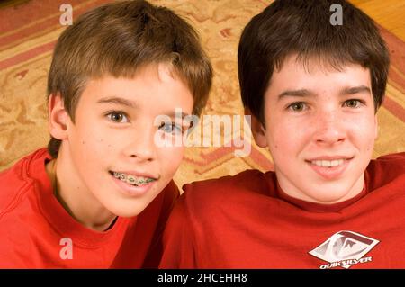 Ritratto dei fratelli di 12 e 13 anni, ragazzo più giovane che indossa le bretelle sui denti Foto Stock
