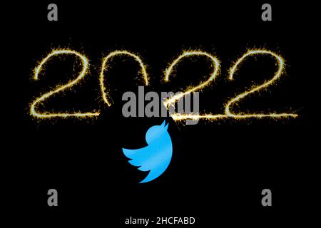 Polonia. 21st Dic 2021. In questa foto è illustrato un logo Twitter visualizzato su uno smartphone e illuminato il nuovo anno 2022 sullo sfondo. (Foto di Filip Radwanski/SOPA Images/Sipa USA) Credit: Sipa USA/Alamy Live News Foto Stock