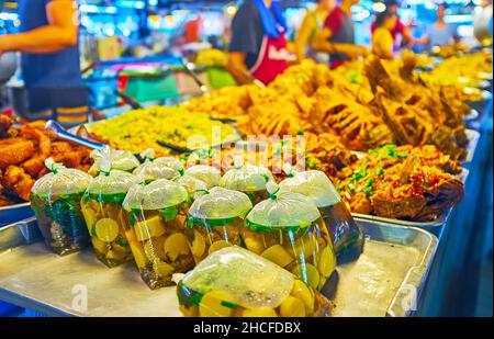 Il mercato di Tanin vanta una varietà di cibi da asporto, come pesce fritto, zuppe in confezioni di plastica, pollo affumicato e insalate, Chiang mai, Thaila Foto Stock