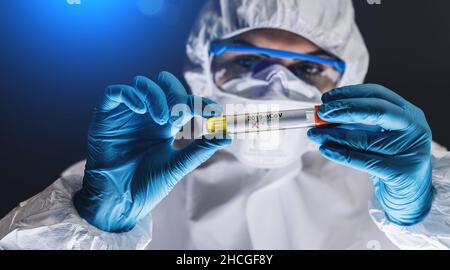 Operatore medico con campione di sangue in laboratorio positivo per il test di Covid-19 o Coronavirus Foto Stock