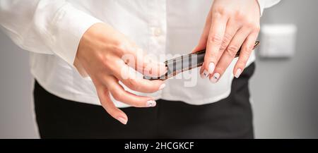 Mani e strumenti curati per una manicure. Mani di manicurista togliere lo strumento per un manicure dalla custodia in pelle in un salone unghie Foto Stock