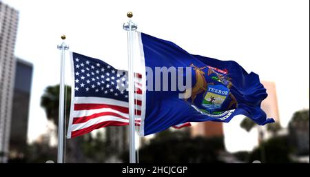 La bandiera dello stato americano del Michigan sventola nel vento con la bandiera americana sfocata sullo sfondo. Il Michigan è stato ammesso all'Unione il Januar Foto Stock
