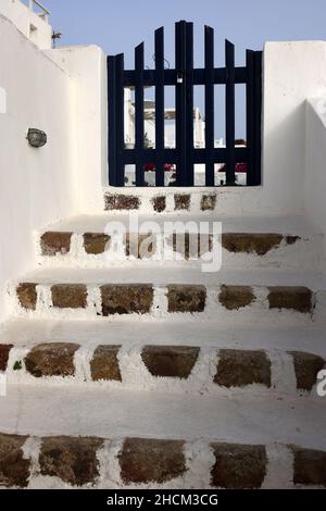 Chiuso il lupetto blu e stretti gradini di pietra, un pezzo di architettura tradizionale sull'isola di Santorini. Grecia Foto Stock