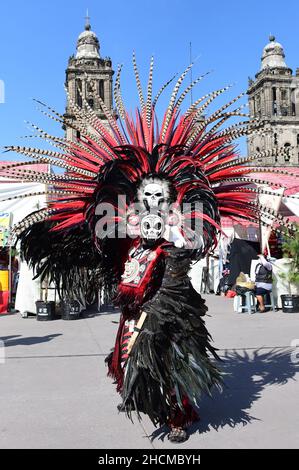 Mexiko Stadt, Messico. 06th Nov 2021. Un uomo che indossa una piume di piume si trova di fronte alla cattedrale sulla Plaza de la Constitucion durante la Fiesta de las Culturas Indigenas. Credit: Kahnert/dpa-Zentralbild/dpa/Alamy Live News Foto Stock