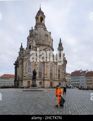 Dresda, Germania. 01st Jan 2022. I dipendenti del dipartimento di pulizia della città sono impegnati a pulire dopo la vigilia di Capodanno sul Neumarkt di fronte alla Frauenkirche. Poiché gli eventi pubblici sono stati in gran parte vietati in Sassonia all'inizio dell'anno e la combustione dei fuochi d'artificio era consentita solo nelle aree private, c'era poca spazzatura in contrasto con gli anni precedenti. Credit: Matthias Rietschel/dpa/Alamy Live News Foto Stock