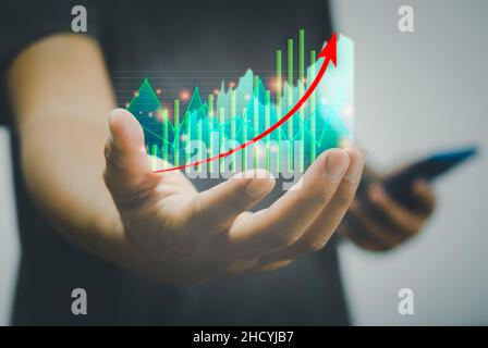 Business finance e concetto di investimento mercato azionario e criptovaluta grafici e grafici di investimento a portata di mano metaveres tecnologia moderna Foto Stock