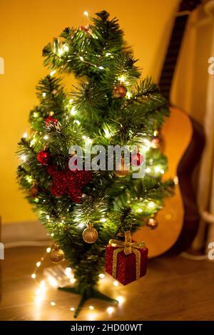 Scatto verticale di un albero di Natale con luci e ornamenti Foto Stock