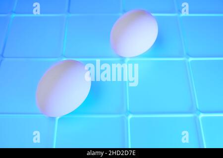 Due uova su un astratto sfondo blu smeraldo Foto Stock