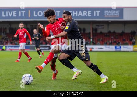 Il Kaine Kesler di Swindon Town (a sinistra) sfidato da Ali Koiki di Northampton Town (a destra) durante la partita della Sky Bet League Two al County Ground di Swindon. Data foto: Sabato 1 gennaio 2022. Foto Stock