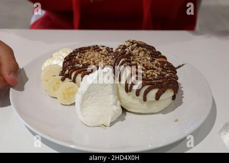 Soffici pancake giapponesi al Fuwa Fuwa di Londra, serviti con Nutella e banana. Foto Stock