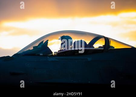 Posizione non divulgata. 21st Dic 2021. Un pilota della US Air Force F-16C Fighting Falcon assegnato al 55th Expeditionary Fighter Squadron attende sulla linea di volo durante un'operazione di rifornimento di hot pit come parte di un'esercitazione Agile Combat Employment in una località non divulgata, il 21 dicembre 2021. ACE è un concetto operativo che sfrutta reti di basi aeree consolidate e austere, Airmen multi-capaci, apparecchiature preposizionali e airlift per implementare, disperdere e manovrare rapidamente la capacità di combattimento in tutto il teatro. Abbinato ad attivazioni di rifornimento, armamento e manutenzione limitata degli aerei Foto Stock