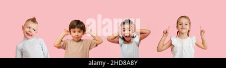 Quattro bambini, ragazzi e ragazze carino che si divertono isolato su sfondo rosa studio. Emozioni, espressione facciale, concetto d'infanzia Foto Stock