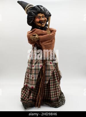 Il Befana con una scopa per streghe su sfondo bianco. Costume da strega tradizionale per il giorno dell'Epifania Italiana. Foto Stock