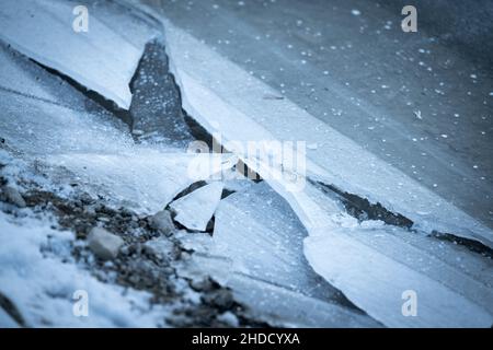 righi di ghiaccio rotti sulla riva di una spiaggia di pietra in una gelida giornata invernale Foto Stock