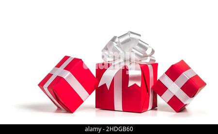 Scatole regalo rosse con arco in argento su sfondo bianco. Foto Stock