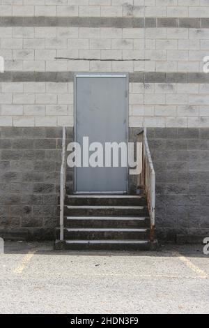 Porta garage sul magazzino e porta regolare sfondo industriale Foto Stock