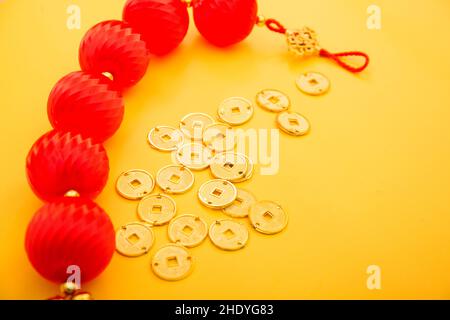 Lunar New Year decoration with lucky gold bar, lucky sacks, and red fish isolated on yellow . Tet Ho Stock Photo