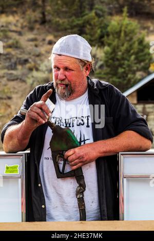 Junior, Longtime Mitchell; Oregon; residente; offre un visitatore un cocktail pompato dalla sua stazione di benzina rubinetto Foto Stock