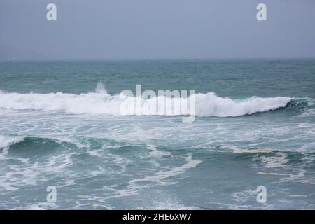 Godrevy, Cornovaglia, 9th gennaio 2022, gente fuori per una passeggiata mattutina in una giornata grigia, umida e triste a Godrevy, Cornovaglia. Sorprendentemente, alcune persone passeggiavano lungo le scogliere per guardare le foche e il faro di Godrevy anche se la temperatura era di 9C, ma con il fattore windchill sembrava molto più freddo.Credit: Keith Larby/Alamy Live News Foto Stock