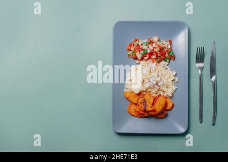 Delizioso cibo minimalista sfondo sudamericano piatto a base di piante patate dolci con cuscus e salsa pivre cilena Foto Stock