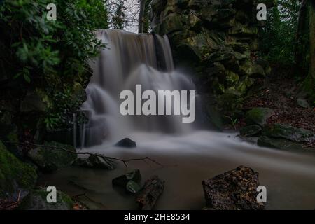 Cascata all'Abney Hall Park dopo la pioggia pesante - Chorlton Brook cascata sopra cascata artificiale. Foto Stock