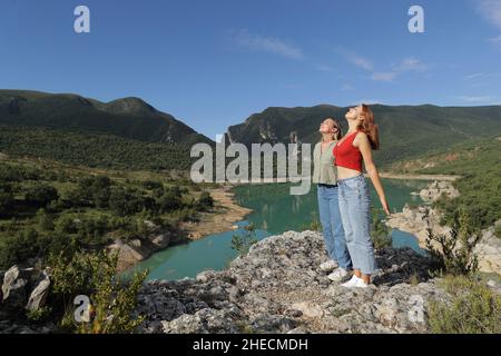 Due amici respirano aria fresca in un lago durante le vacanze estive Foto Stock