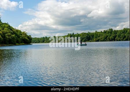 Fisheman in barca a Louth Oughter nel Killykeen Forest Park durante l'estate, in Irlanda Foto Stock