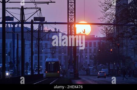 Berlino, Germania. 11th Jan 2022. Il sole tramontato è visibile da Karl-Liebknecht-Straße. Credit: Annette Riedl/dpa/Alamy Live News Foto Stock