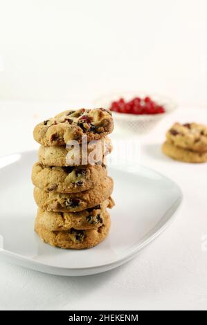 Biscotti al mirtillo con gocce di cioccolato bianco su sfondo bianco. Foto Stock