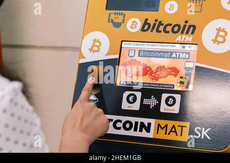 Primo piano la donna utilizza una criptovaluta bitcoin ATM, gennaio 2022, Poprad, Slovacchia. Foto Stock