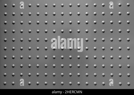 sfondo armonico metallico grigio con macchie in pattern regolare Foto Stock