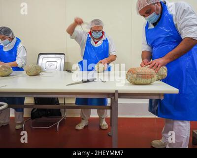Lavorazione manuale e finissaggio di culatello, coppa e prosciutto in impianti di produzione di delicatessen a Parma Foto Stock