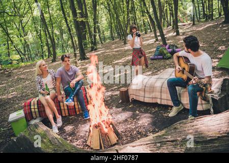 Ritratto di attraente allegro quattro persone che trascorrono tempo libero nel parco selvaggio su aria fresca riscaldamento di messa a fuoco all'aperto Foto Stock