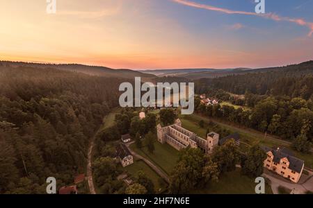 Germania, Turingia, Königsee, Paulinzella, rovine del monastero, villaggio, panoramica, montagne, foresta, alba, vista aerea Foto Stock