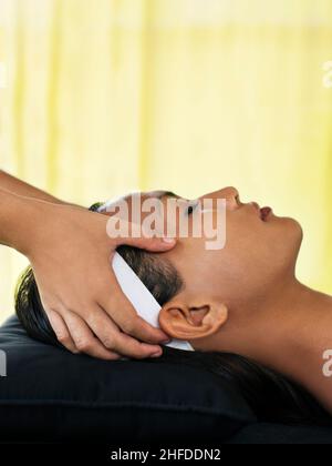 Donna che riceve un rinfrescante trattamento viso naturale presso il padiglione relax all'aperto della Rebab Spa a Kayumanis Gangsa, Bali, Indonesia Foto Stock